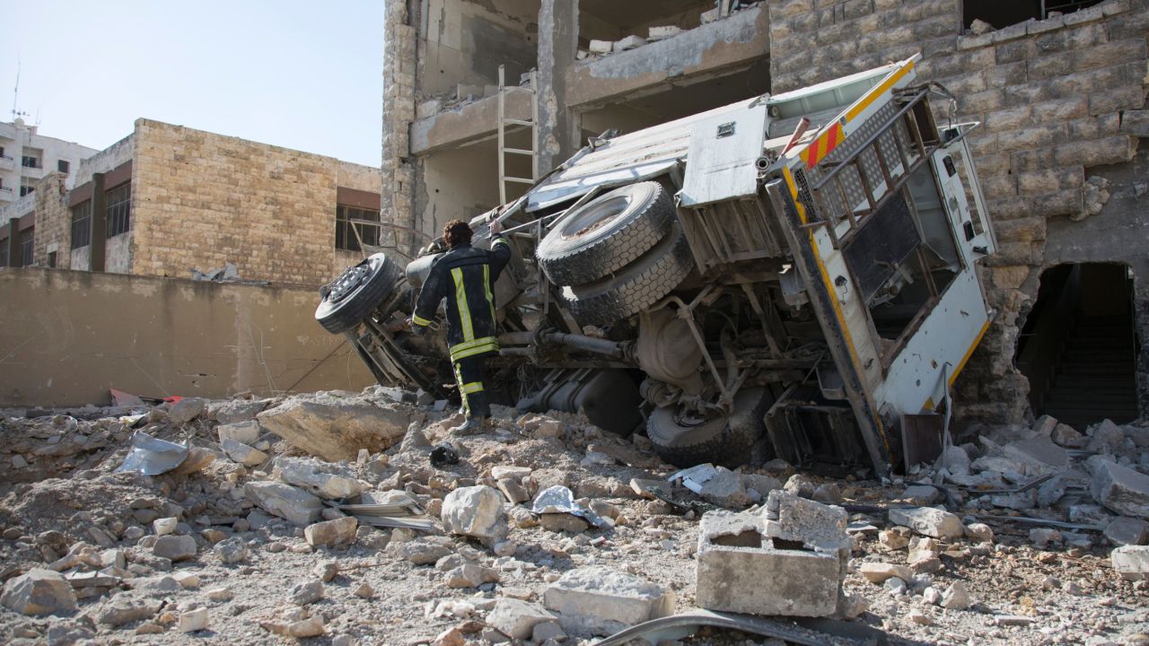 A Syrian man checks the damage following an air strike in the rebel-held Ansari district in the northern Syrian city of Aleppo on September 23, 2016.