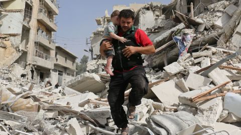 A Syrian baby is carried from the rubble following the bombing of a building in Aleppo on Wednesday, September 21. 