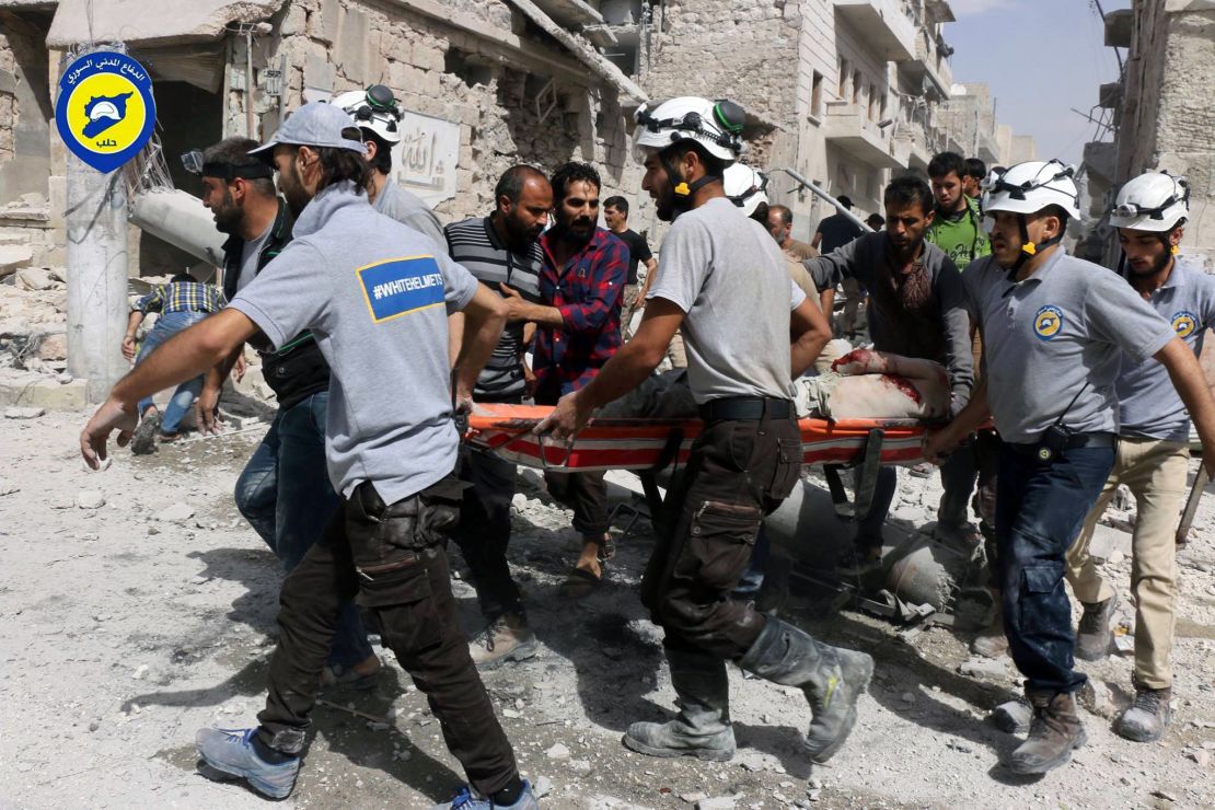 Rescue workers work the site of airstrikes in  the al-Sakhour neighborhood.