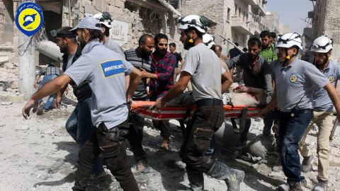 Rescue workers in the al-Sakhour neighborhood, eastern Aleppo, Syria, Wednesday Sept. 21, 2016.
