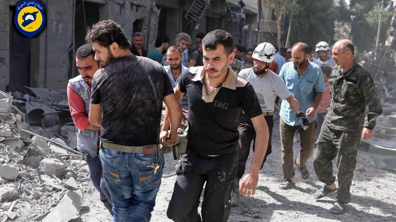 Rescue workers work the site of airstrikes in al-Mashhad neighborhood in the rebel-held part of eastern Aleppo, Syria, Wednesday Sept. 21, 2016.