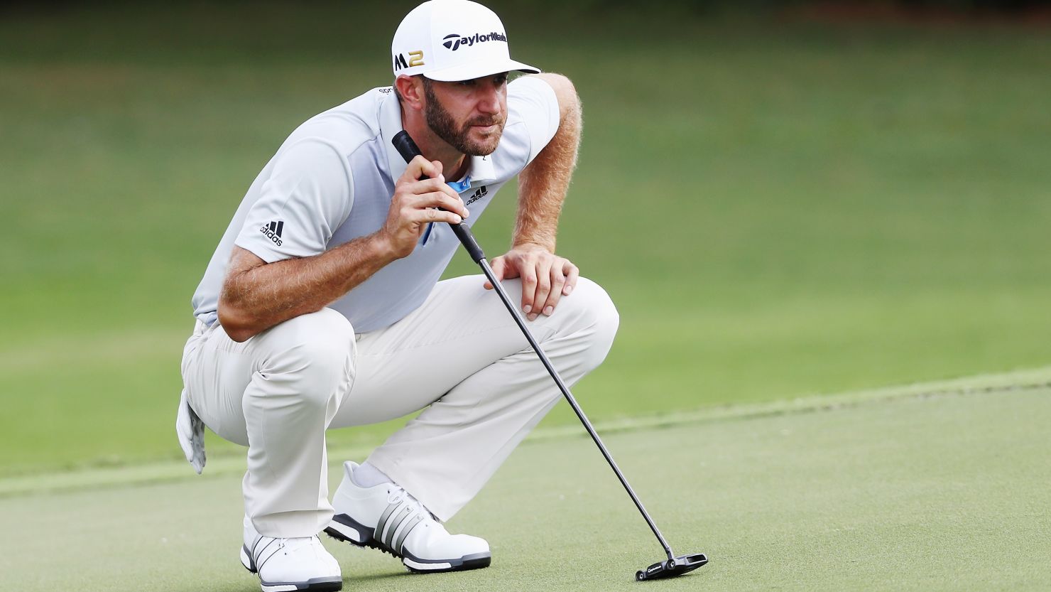 Eyes on the prize: Dustin Johnson lines up a putt at the Tour Championship Thursday.
