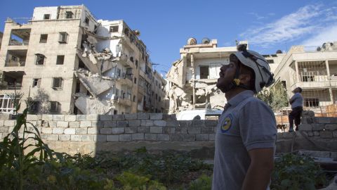 A Syrian rescuer looks towards the sky following an air strike in the rebel-held Ansari district of Aleppo on Thursday, September 23.