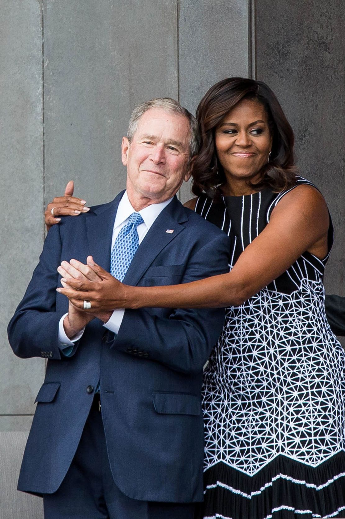 Former US President George W. Bush receives a hug from US First Lady Michelle Obama on September 24, 2016 in Washington, D.C.  