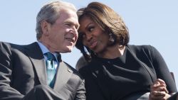 Former US President George W. Bush speaks with First Lady Michelle Obama  during an event marking the 50th Anniversary of the Selma to Montgomery civil rights marches at the Edmund Pettus Bridge in Selma, Alabama, March 7, 2015.