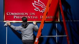 A worker cleans a sign for the Commission on Presidential Debates prior to the second presidential debate to be held at the David Mack Center at Hofstra University in Hempstead, New York, October 16, 2012. 