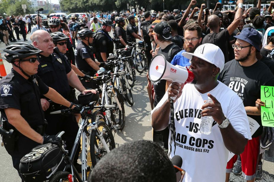 Protesters stand outside Bank of America Stadium in Charlotte, North Carolina, during the NFL football game between the Carolina Panthers and the Minnesota Vikings on Sunday, September 25. Violent protests erupted on Tuesday after the death of Keith Lamont Scott, who was shot by a police officer in an apartment complex parking lot. Charlotte-Mecklenburg Police Chief Kerr Putney said Scott exited his car with a gun and that he was shot after he wouldn't drop it. Scott's family said he was unarmed and sitting in his car reading a book.