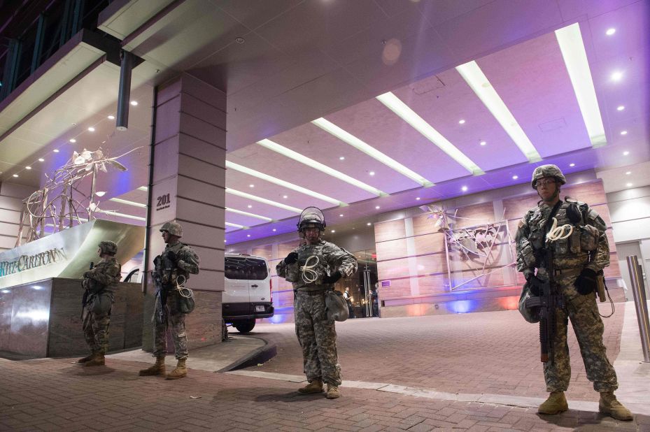 Members of the National Guard stand watch in front of a Charlotte hotel on Friday, September 23.