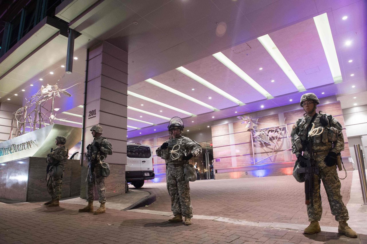 Members of the National Guard stand watch in front of a Charlotte hotel on Friday, September 23.