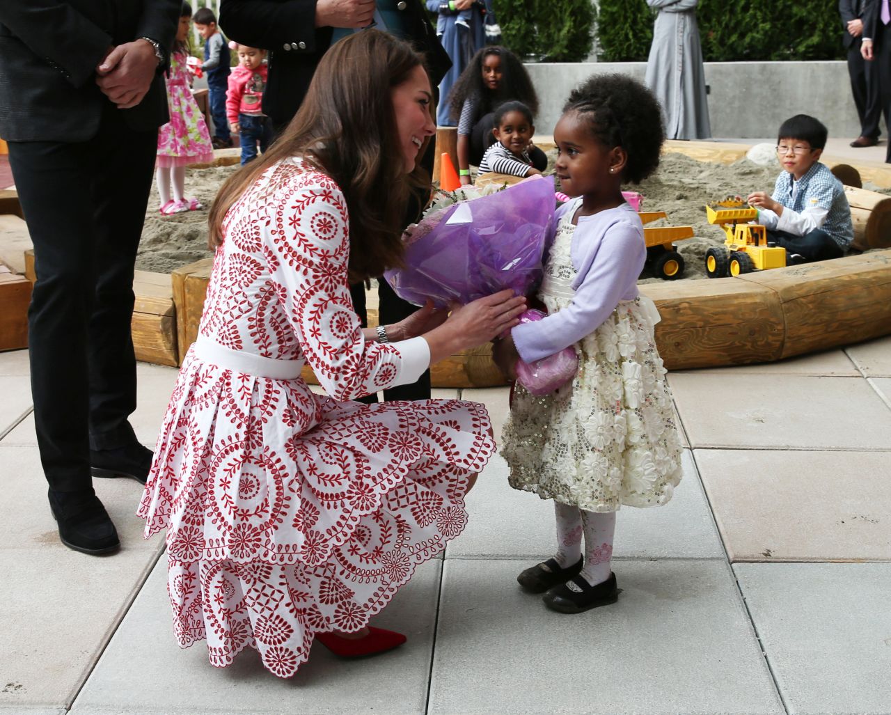 Catherine receives flowers from a young girl at the welcome center of the Immigrant Services Society of British Columbia.