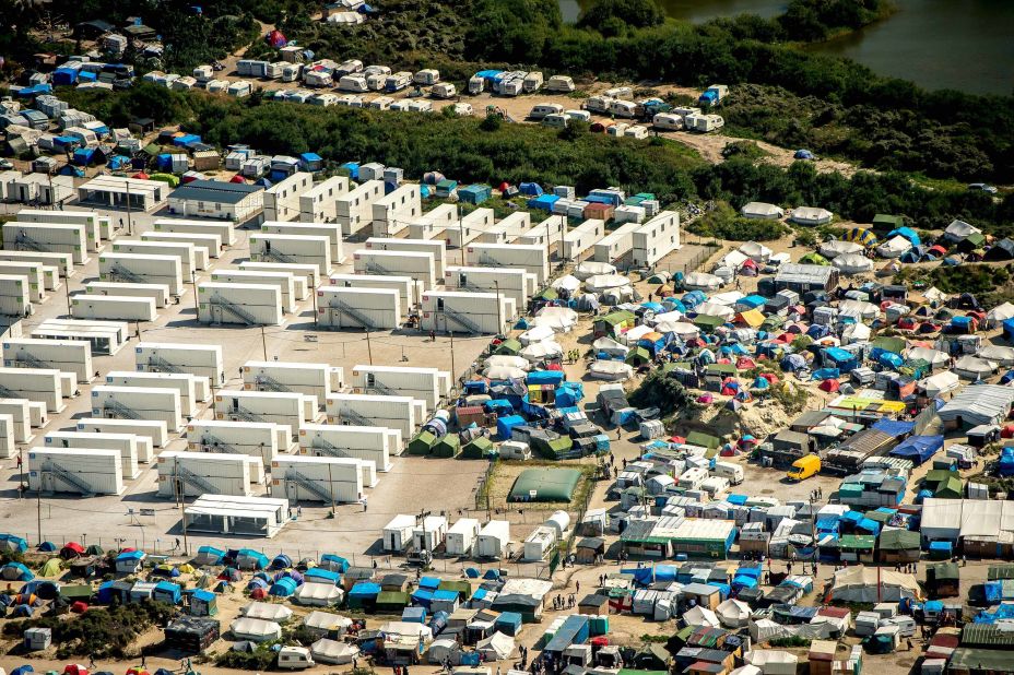 This aerial view taken Tuesday, August 16, shows the tents and shipping containers housing migrants in "The Jungle."