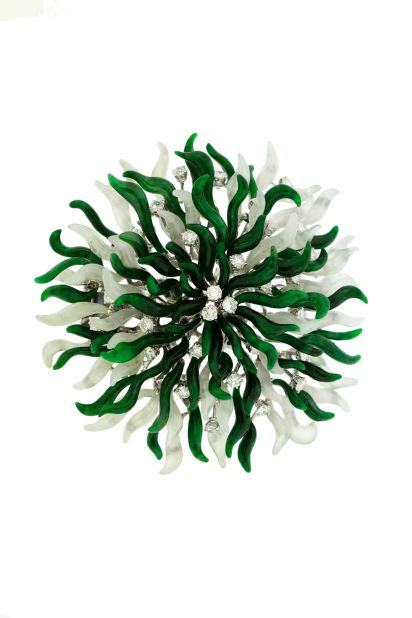 "Purchasing jadeite jewelry often comes with sentimental reason for general Chinese. More Western clients are into fine workmanship, carving details, and they are crazy about originality," says Eddy Hui, the artistic director of Edward Chiu Jewellery Art in Hong Kong. <br /><br />This 18K white gold Edward Chiu Jewellery Art brooch features green jadeite, white jadeite, black jadeite and diamonds. 
