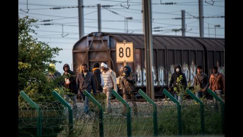 Several migrants successfully cross the Eurotunnel terminal in July 2015 as they try to reach a shuttle to the UK.