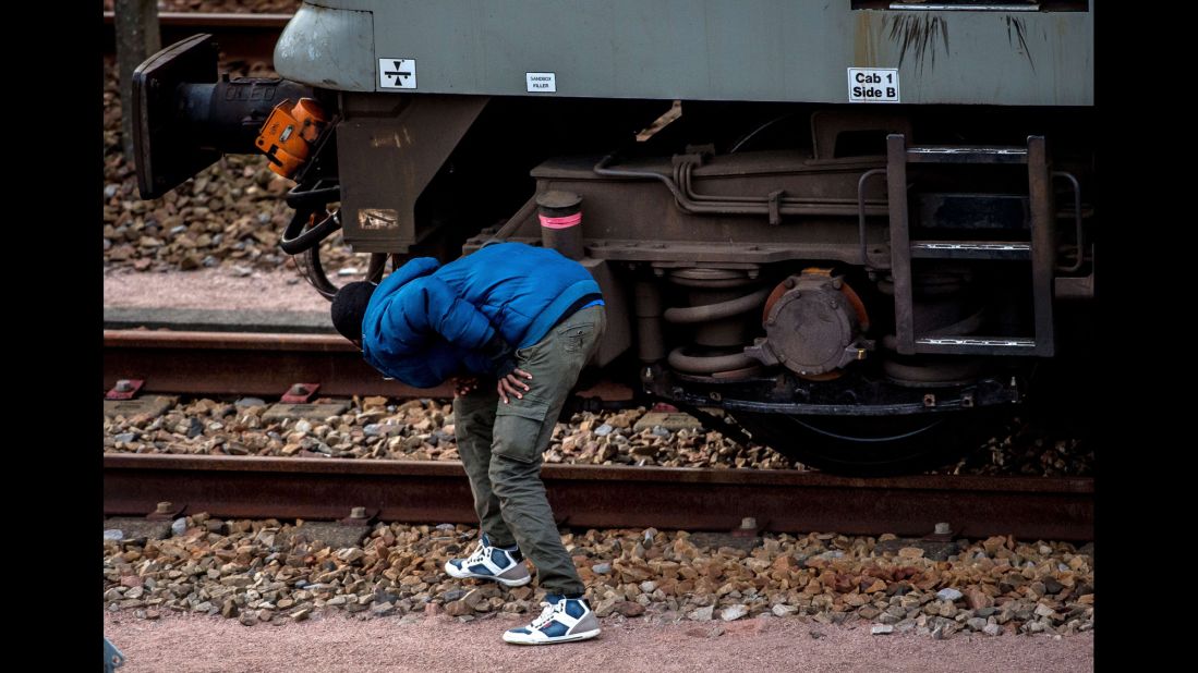 A migrant hides on the train tracks in the direction of the Eurotunnel terminal in August 2015.