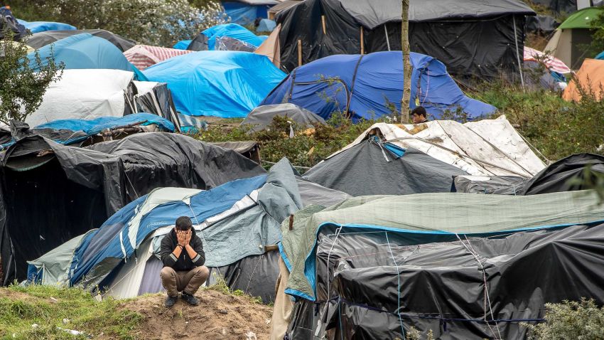 A picture taken  in Calais on October 7, 2015 shows a site dubbed the "New Jungle", where some 3,000 people have set up camp -- most seeking desperately to get to England, . The slum-like migrant camp sprung up after the closure of notorious Red Cross camp Sangatte in 2002, which had become overcrowded and prone to violent riots. However migrants and refugees have kept coming and the "New Jungle" has swelled along with the numbers of those making  often deadly attempts to smuggle themselves across the Channel.  AFP PHOTO / PHILIPPE HUGUEN        (Photo credit should read PHILIPPE HUGUEN/AFP/Getty Images)