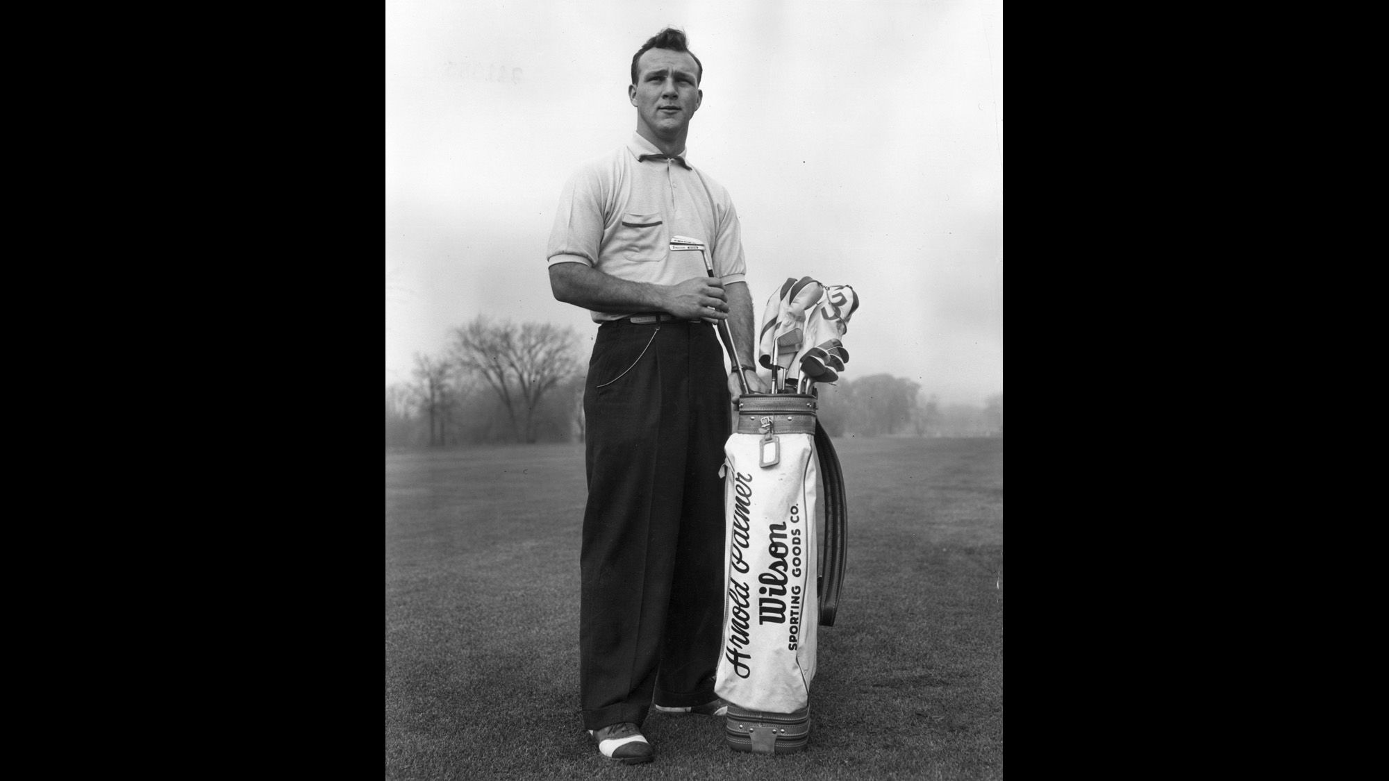 Pictured here circa 1953, a young Arnold Palmer pulls a driving iron from a golf bag. Palmer died Sunday evening, Septmeber 26, while awaiting cardiac surgery at a Pittsburgh hospital, according to a statement from his company.