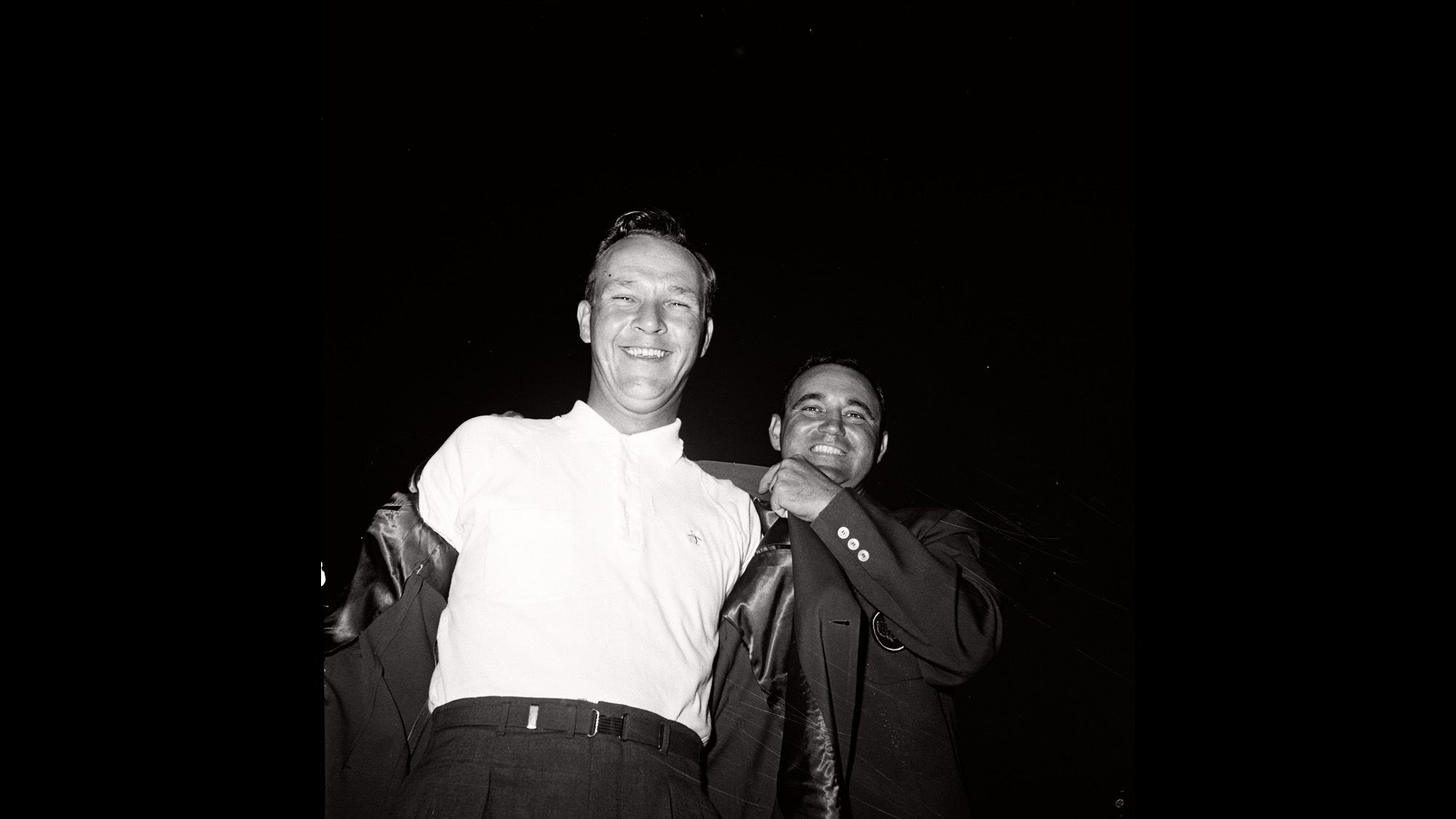 Palmer receives the coveted "Green Jacket" from Doug Ford after winning his first Masters at Augusta National Golf Club on April 6, 1958.