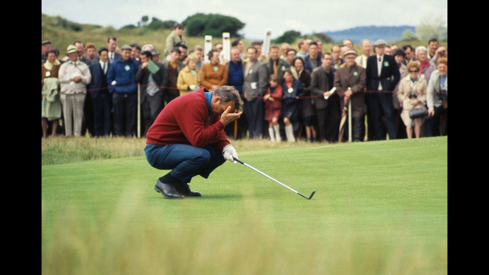 It didn't always go "the King's" way. Here he is seen holding his head as he kneels on the third green during the 1968 British Open at Carnoustie.