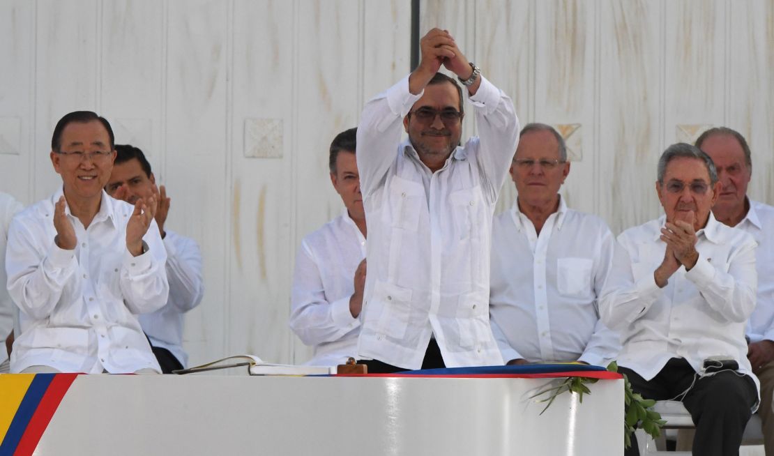 The head of the FARC, Timoleon Jimenez, aka Timochenko, gestures as he signs the historic peace agreement with the Colombian government on September 26, 2016.