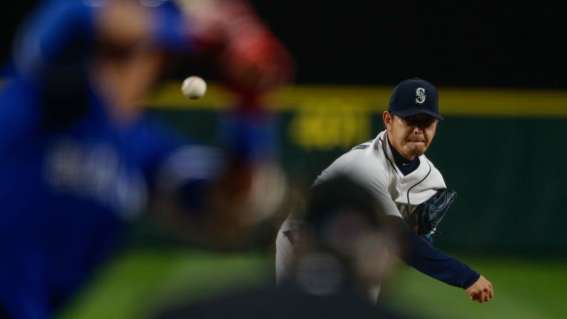 Seattle pitcher Hisashi Iwakuma throws the ball to a Toronto batter during a Major League Baseball game on Tuesday, September 20.