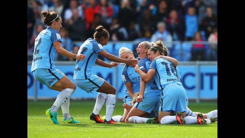 Manchester City players celebrate a goal against Chelsea during a Women's Super League match in Manchester, England, on Sunday, September 25. Manchester City won 2-0 to clinch its first league title.