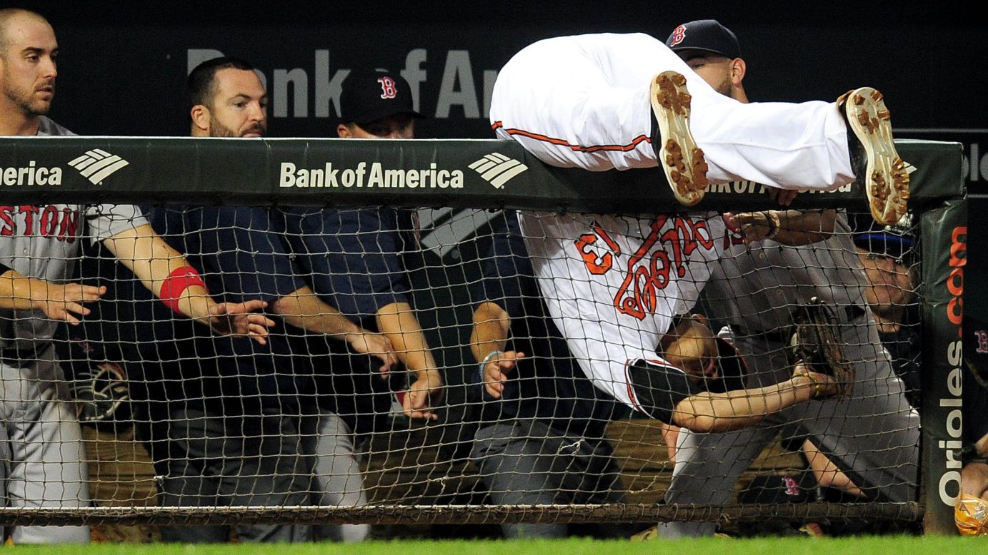 Baltimore third baseman Manny Machado falls over a dugout railing while catching a foul ball against Boston on Wednesday, September 21.
