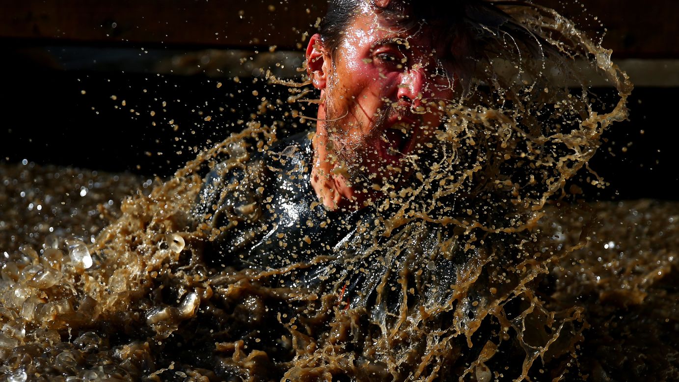 A participant splashes in water during a Tough Mudder race in Horsham, England, on Saturday, September 24.