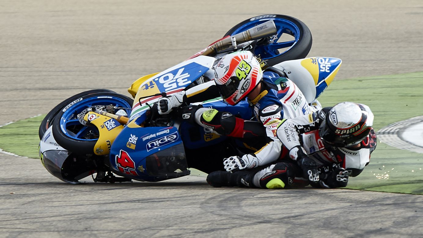 Stefano Valtulini, left, and Fabio Spiranelli crash into each other during a Moto3 race in Alcaniz, Spain, on Sunday, September 25.