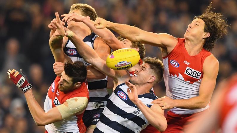 The Geelong Cats and the Sydney Swans compete for a ball during an Australian Football League match in Melbourne on Friday, September 23.