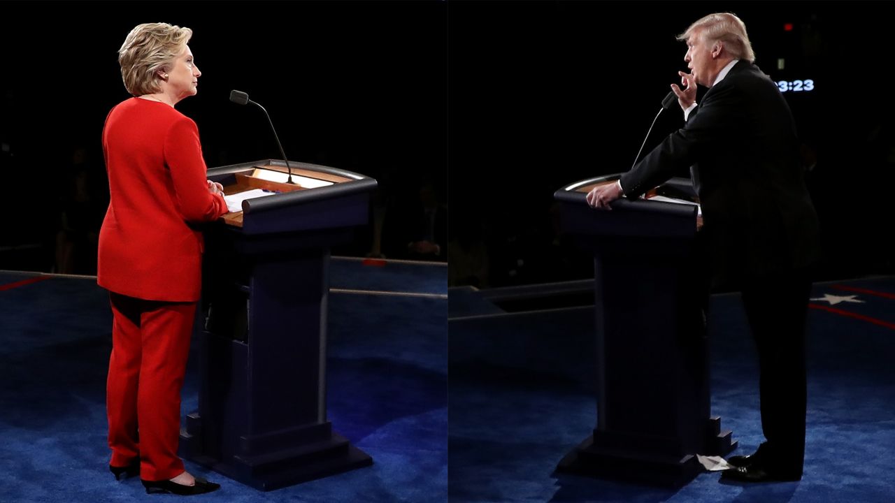 Republican presidential nominee Donald Trump speaks as Democratic presidential nominee Hillary Clinton listen during the Presidential Debate at Hofstra University on Monday, September 26 in Hempstead, New York. 