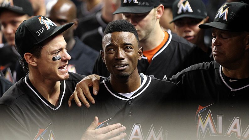 Miami Marlins second baseman Dee Gordon is consoled by teammates after hitting a leadoff home run against the New York Mets on Monday, September 26. Gordon and the rest of the Marlins were mourning teammate Jose Fernandez, <a href="http://www.cnn.com/2016/09/25/us/mlb-pitcher-jose-fernandez-dead/" target="_blank">who died in a boating accident</a> Sunday at the age of 24. All the Marlins wore Fernandez jerseys during their game on Monday.