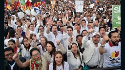 Colombians gather in the Bogota's Bolivar main square on September 26, 2016, to celebrate the historic peace agreement between the Colombian government and the Revolutionary Armed Forces of Colombias (FARC). Colombian President Juan Manuel Santos and the leader of the FARC rebels, Rodrigo Londoño -- aka Timoleon Jimenez or Timochenko -- are due to sign the historic peace deal to end a five-decade war. The conflict has drawn in several leftist rebel groups, right-wing paramilitaries and drug gangs, killing 260,000 people, leaving 45,000 missing and uprooting 6.9 million. / AFP / GUILLERMO LEGARIA        (Photo credit should read GUILLERMO LEGARIA/AFP/Getty Images)