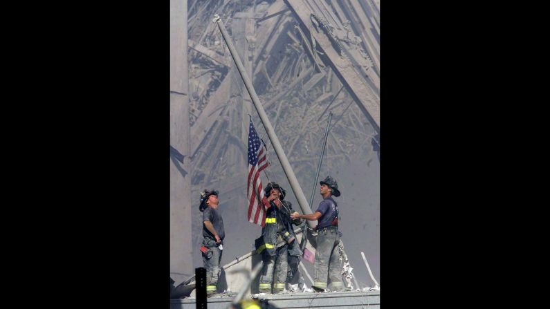Firefighters George Johnson, Dan McWilliams and Billy Eisengrein raise a flag at ground zero in New York after the terror attacks on September 11, 2001. The scene was immortalized by photographer Thomas E. Franklin. The image has been widely reproduced in the decade since it was first published. <a href="index.php?page=&url=http%3A%2F%2Fwww.cnn.com%2F2013%2F09%2F01%2Fworld%2Fgallery%2Ficonic-images%2Findex.html">View 25 of history's most iconic photographs.</a>