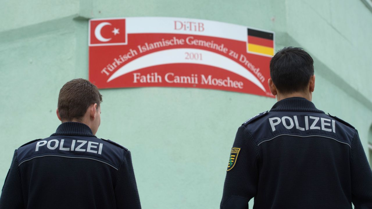 Police stand guard Tuesday at the Fatih Camii mosque in Dresden after a bomb attack.