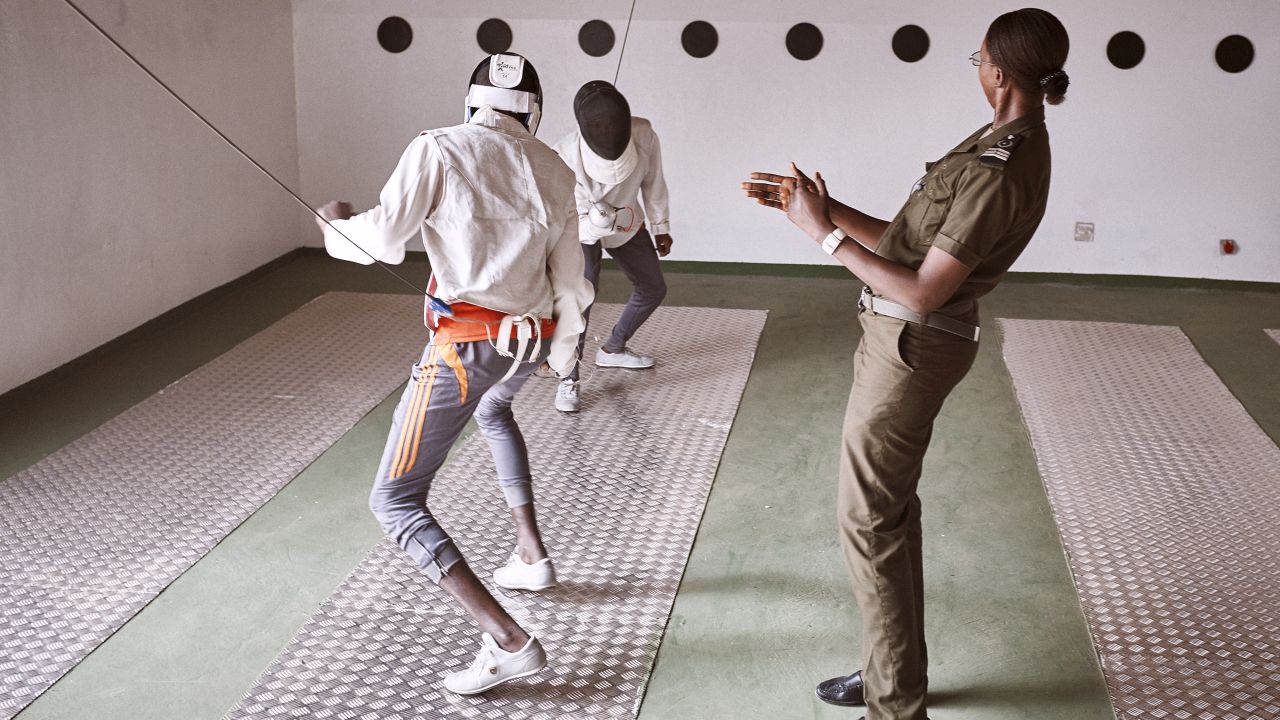 Prison guard Fatoumata Sy referees a fencing match between minors.