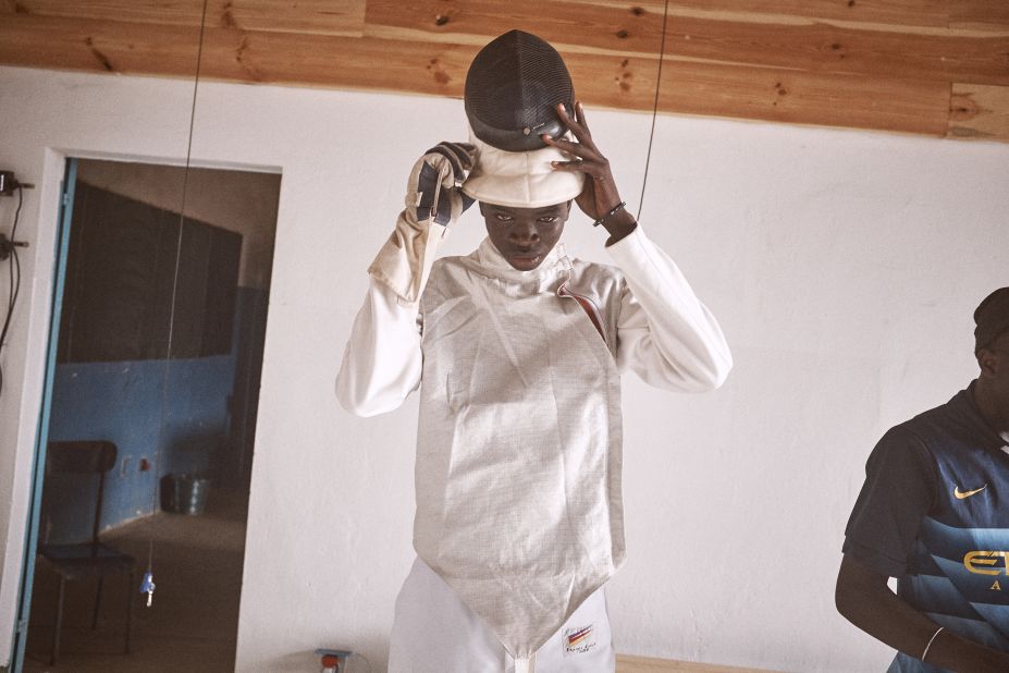 Daouda, 17 years old dresses in preparation for a fencing match. Child beggars and street children are also part of the classes and practice alongside incarcerated youths. More than 100 jailed minors have taken part in the program.<br />