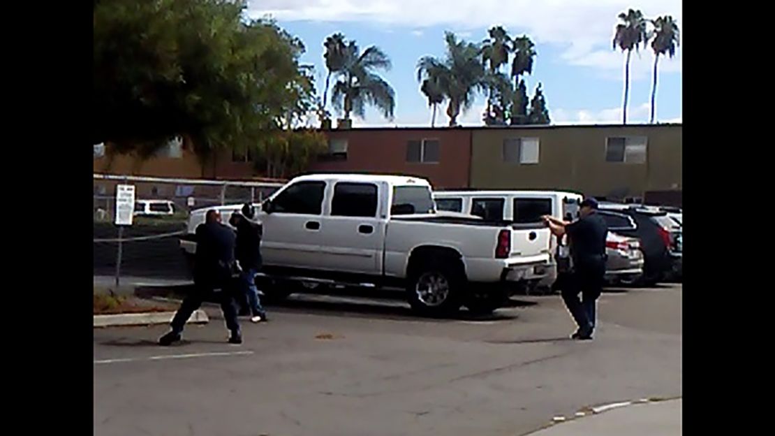 In a photo from police, officers engage a man they say was acting "erratically."