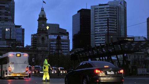 Police direct traffic around downtown Adelaide after the power network stopped working, creating a broad blackout across the city.