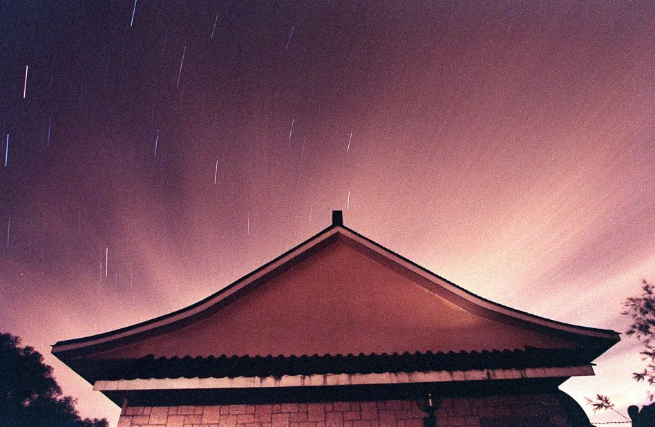 Stars streak above a building on Tai Mo Shan, Hong Kong's tallest mountain, during a Leonid meteor shower.