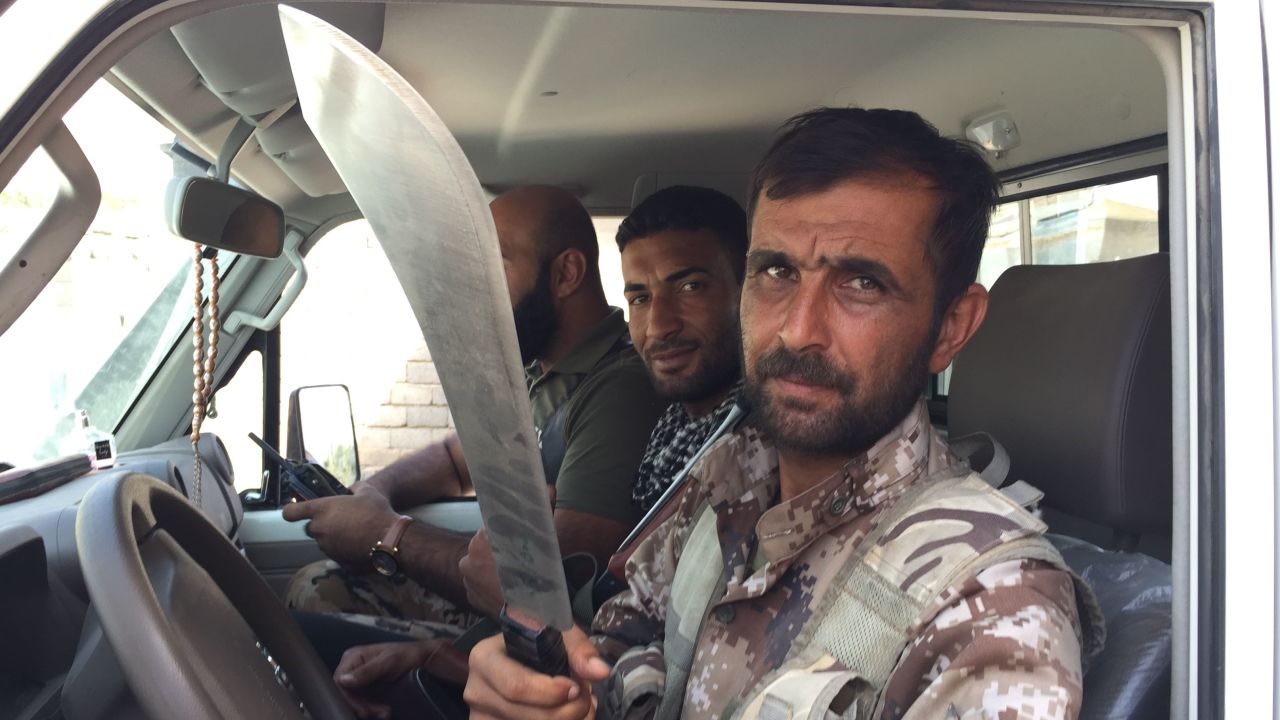 A man shows a machete to CNN's Ben Wedeman.