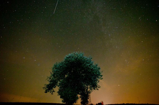 A shooting star crosses the night sky near Muenchsteinach, southern Germany, during the peak in activity of the annual Perseids meteor shower on August 13, 2015. 