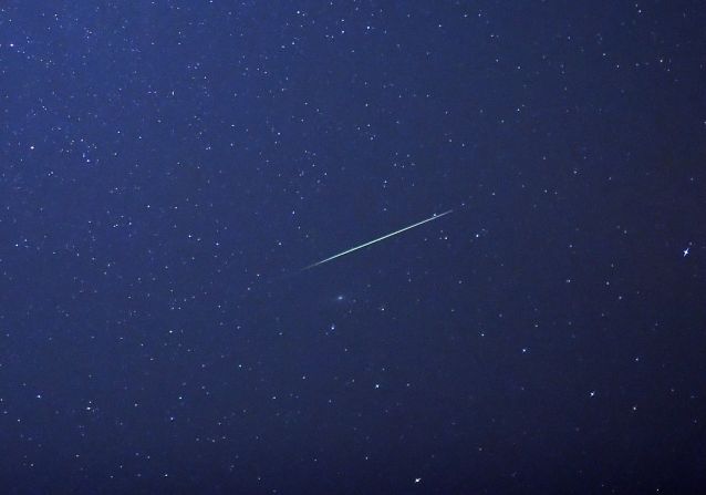 A shooting star crosses the sky over eastern Germany, during the peak in activity of the annual Perseids meteor shower on August 13, 2015. 