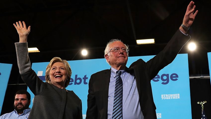 Democratic presidential nominee former Secretary of State Hillary Clinton (L) and U.S. Sen. Bernie Sanders (I-VT) greet supporters during a campaign rally at University of New Hampshire on September 28, 2016 in Durham, New Hampshire. 