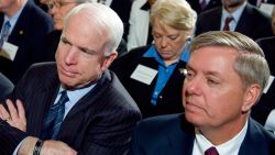 Arizona Republican Senator John McCain (C) listens alongside Connecticut Democrat Senator Joe Lieberman (L) and South Carolina Republican Senator Lindsey Graham (R) during the opening of the Fiscal Responsibility Summit hosted by US President Barack Obama in the East Room of the White House in Washington, DC, February 23, 2009. 