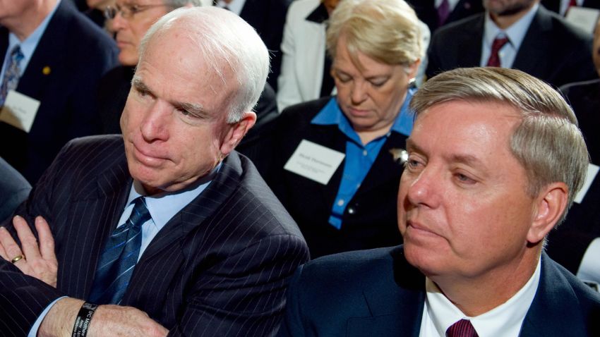 Arizona Republican Senator John McCain (C) listens alongside Connecticut Democrat Senator Joe Lieberman (L) and South Carolina Republican Senator Lindsey Graham (R) during the opening of the Fiscal Responsibility Summit hosted by US President Barack Obama in the East Room of the White House in Washington, DC, February 23, 2009.