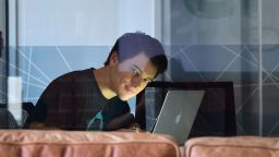 Michael Schneider of tech startup "Getservice" poses behind a glass window at company office in Beverly Hills, California on March 4, 2016. 
 