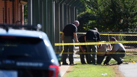 Members of law enforcement investigate an area at Townville Elementary School on Wednesday, Sept. 28, 2016, in Townville, S.C.   A teenager opened fire at the South Carolina elementary school Wednesday, wounding two students and a teacher before the suspect was taken into custody, authorities said.  (AP Photo/Rainier Ehrhardt)