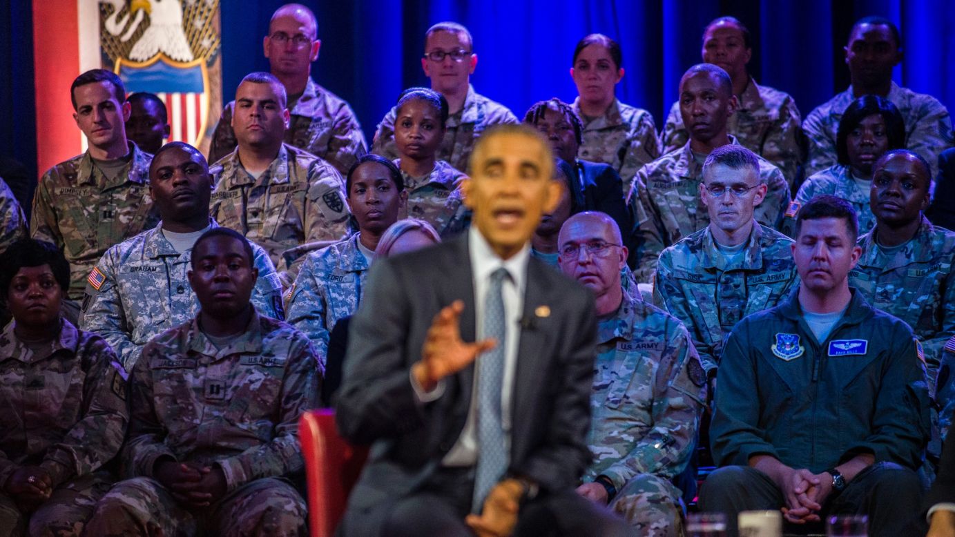 Military members watch Obama speak.