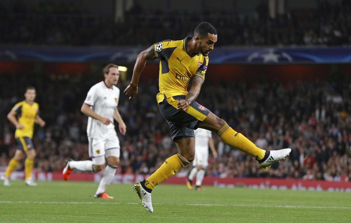Theo Walcott scored twice as Arsenal eased past FC Basel 2-0 in London.