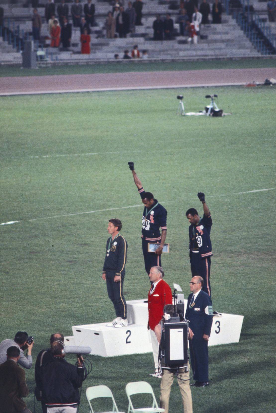 American sprinters Tommie Smith and John Carlos bow their heads and raise gloved fists in protest at the 1968 Olympics in Mexico City.
